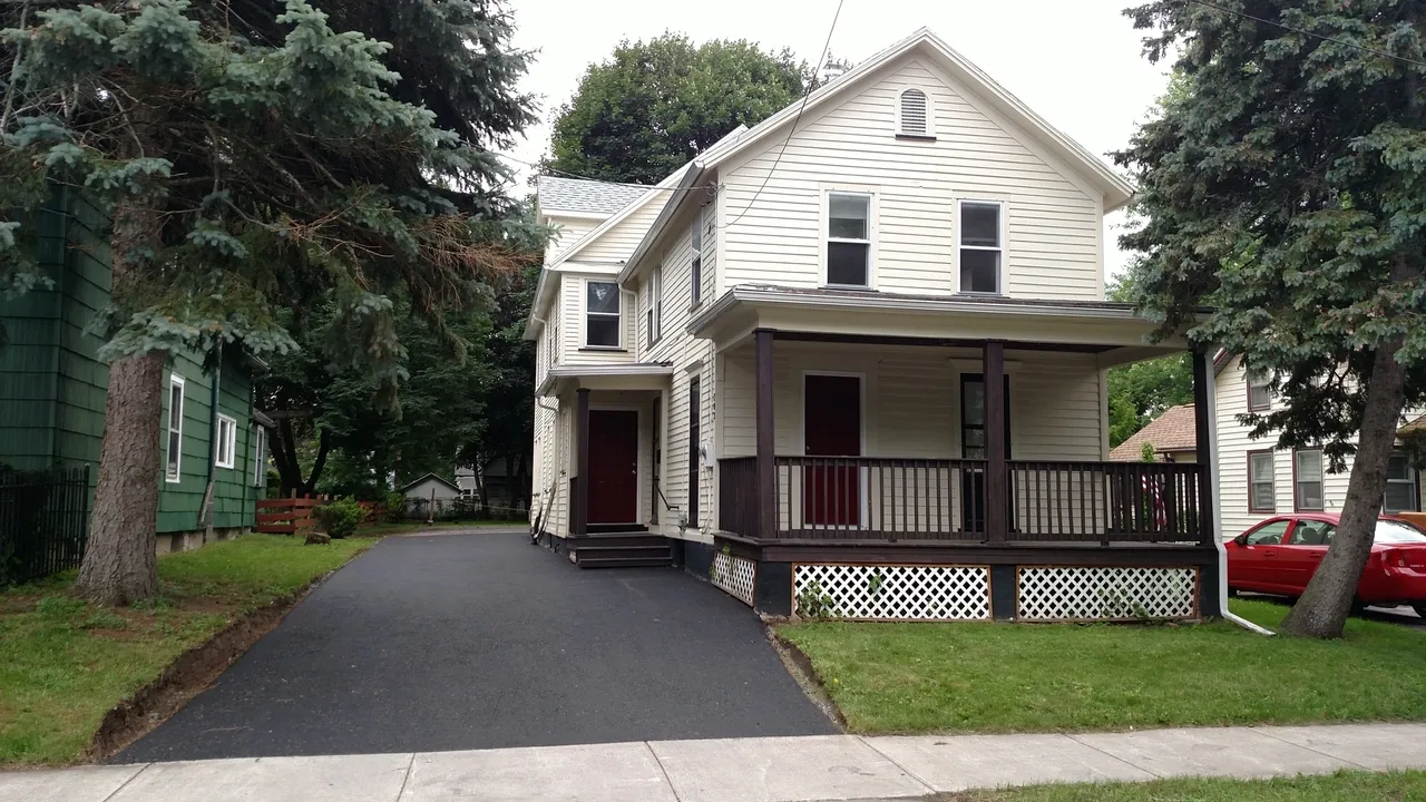 Two-story house with a front porch.