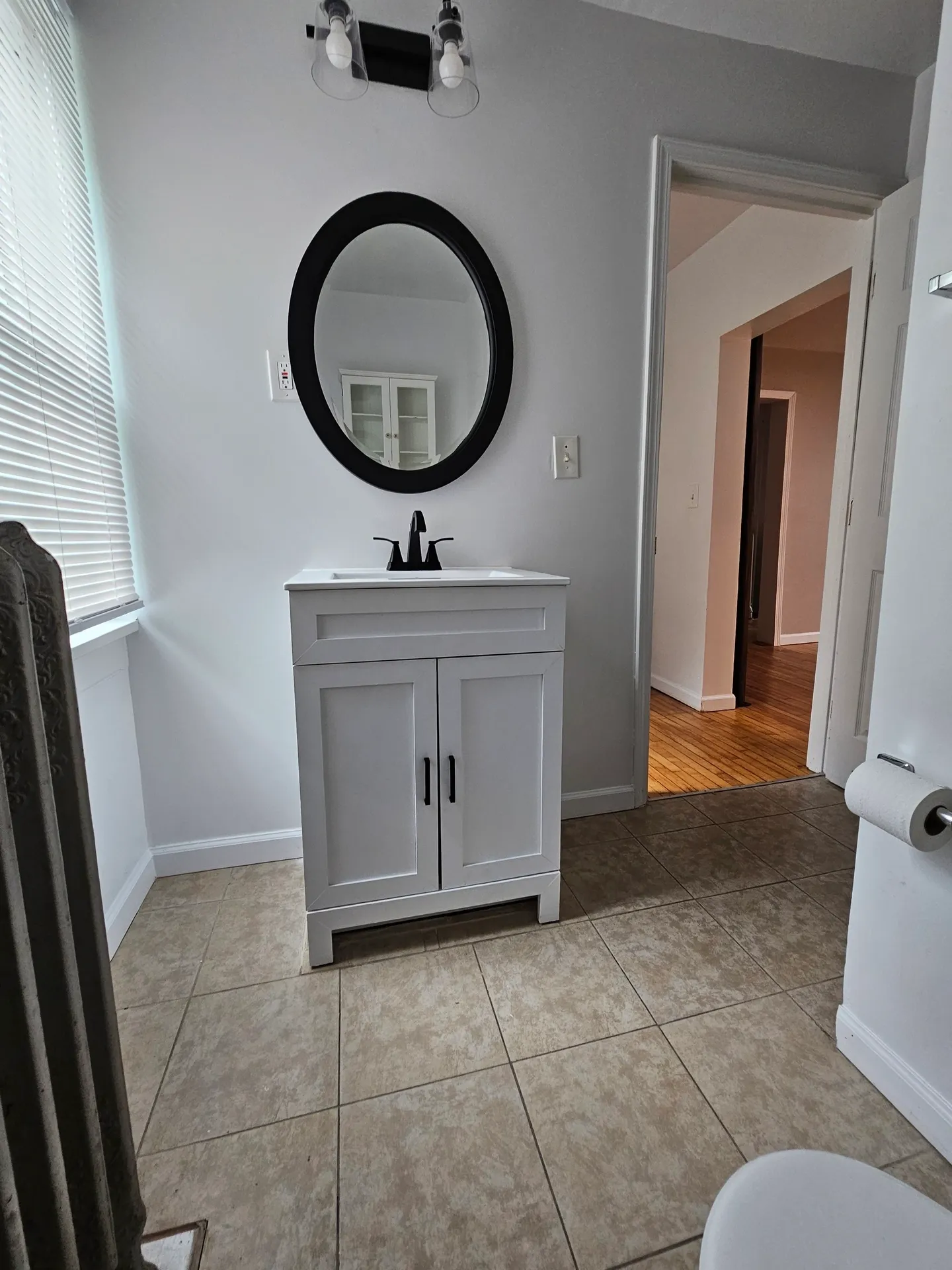 Small bathroom with vanity and mirror.