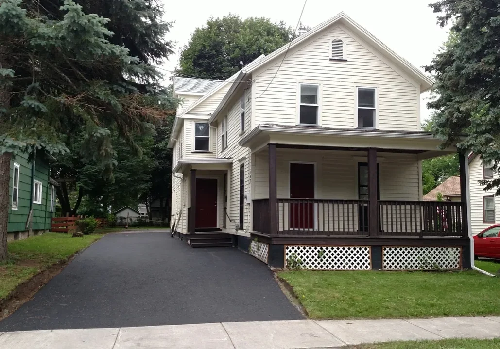 Two-story house with a front porch.